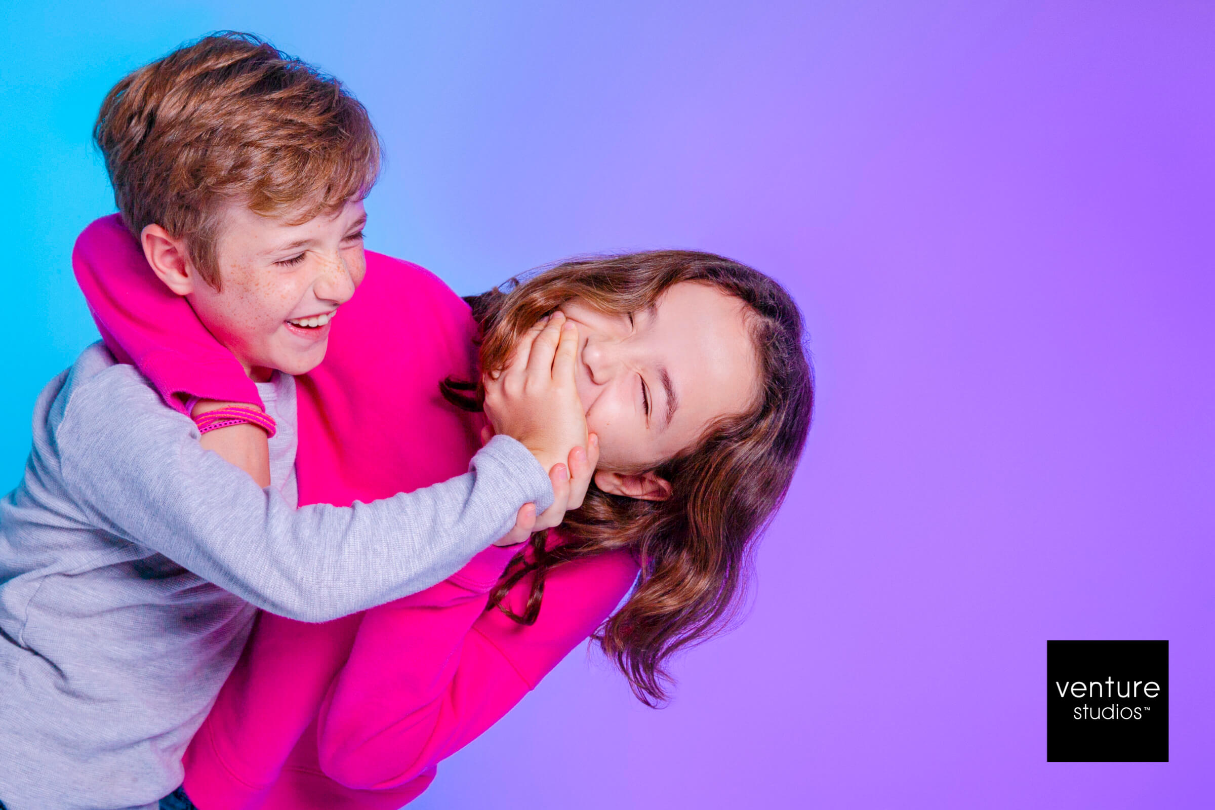 boy covering girls mouth