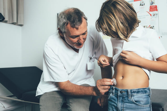 Doctor helping to put an insulin pump