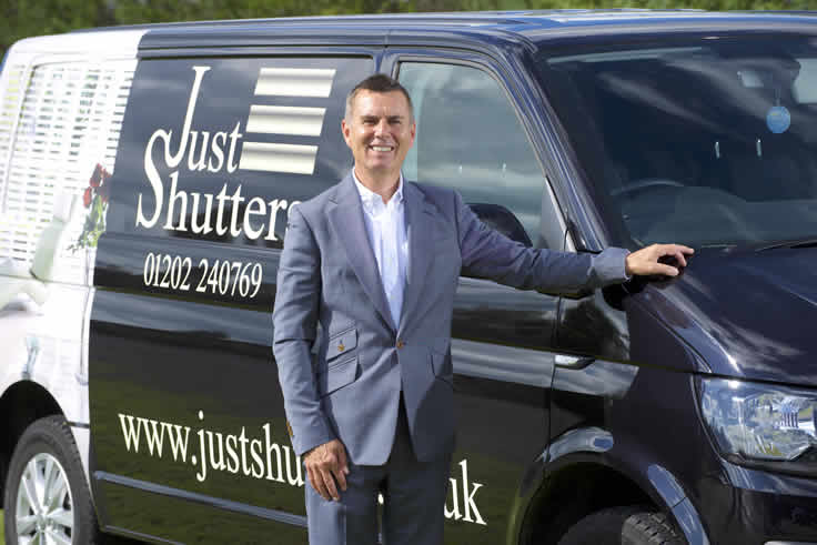 Man with Just shutters van